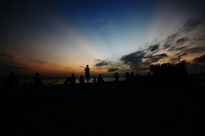 Silhouette people against sky during sunset