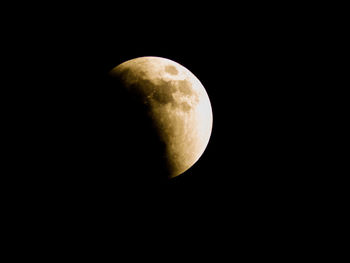 Low angle view of moon over black background