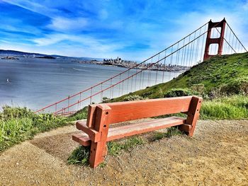 Red wooden bench overlook golden gate bridge over bay