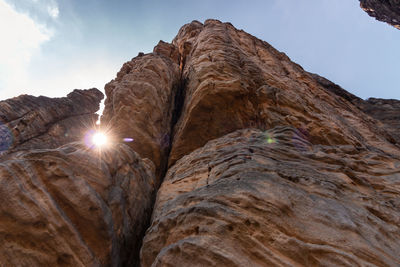 Low angle view of rock formation against sky