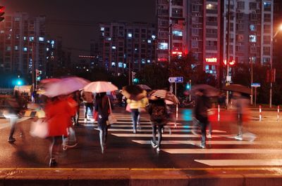 People on wet street at night