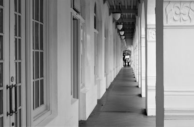 People walking in alley amidst buildings