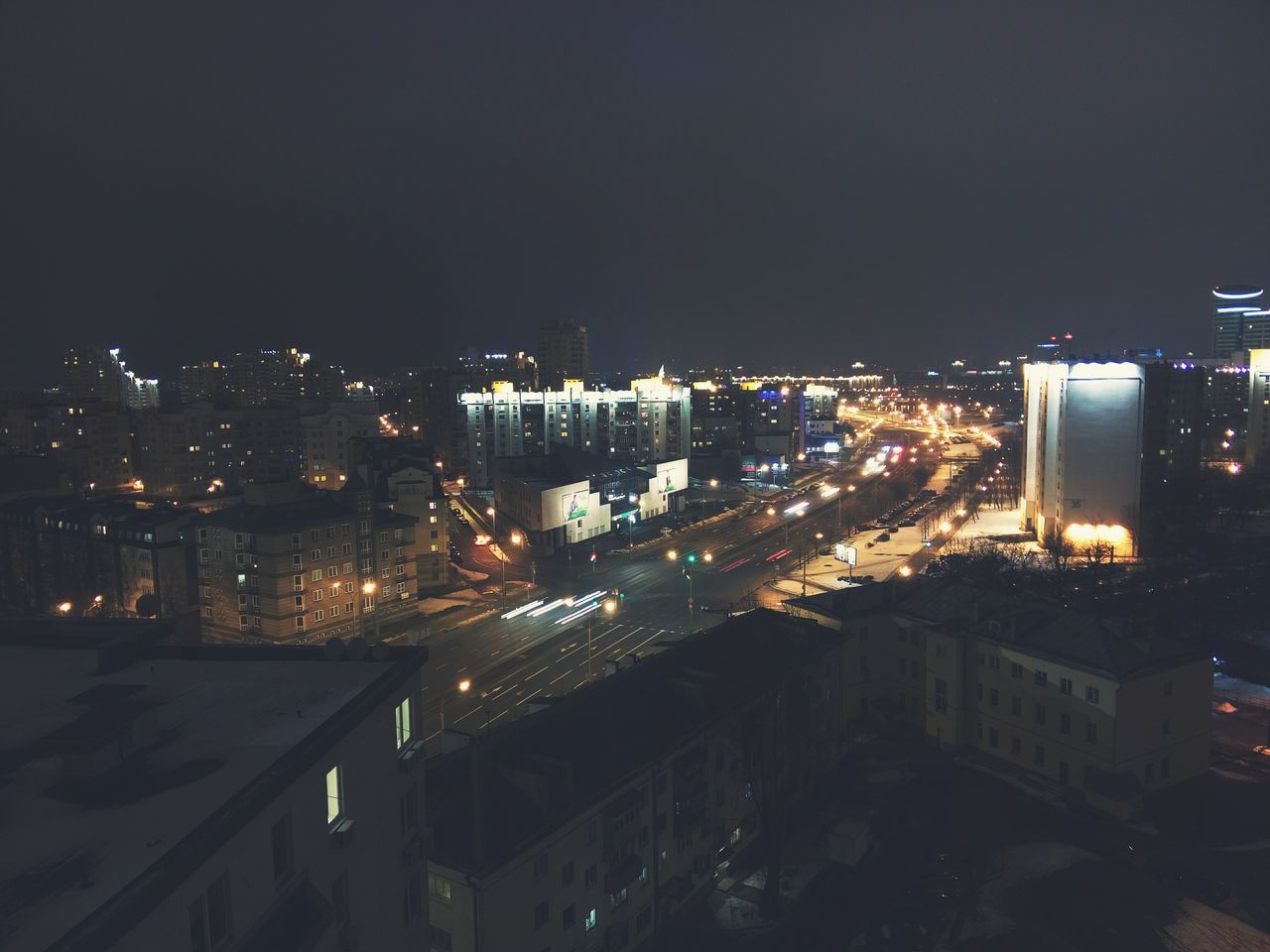 illuminated, night, building exterior, architecture, built structure, city, cityscape, high angle view, residential building, residential structure, residential district, city life, copy space, clear sky, lighting equipment, sky, street, outdoors, crowded, street light