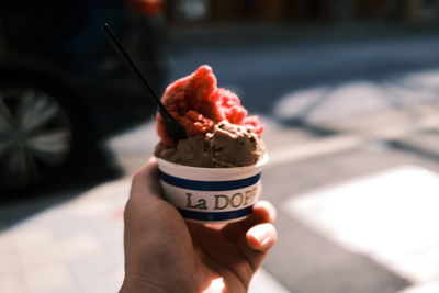 Close-up of hand holding ice cream