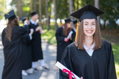 Portrait of woman wearing graduation gown