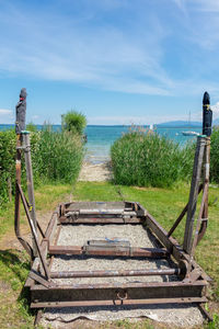 Rear view of plants by sea against sky