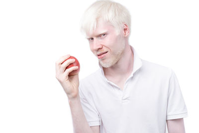 Portrait of smiling man standing against white background