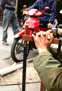 Low section of man with bicycle on street