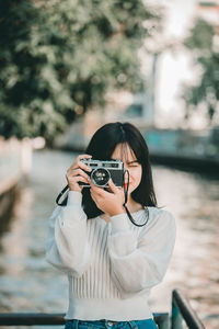 Portrait of woman photographing