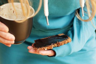 Midsection of person holding bread