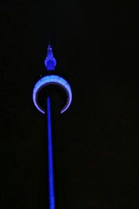 Low angle view of communications tower at night