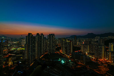 High angle view of illuminated buildings against sky at night