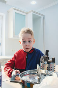 Portrait of cute girl playing on table at home