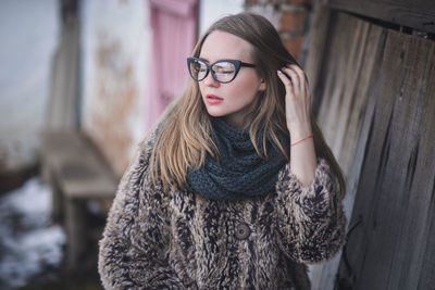 Young woman wearing eyeglasses while standing outdoors