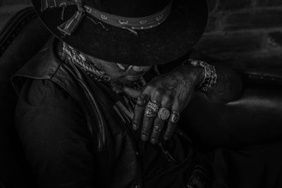 High angle view of man wearing rings and tattoos