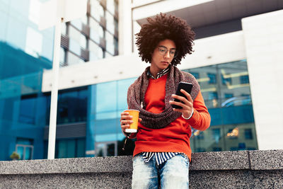 Young woman using smart phone outdoors