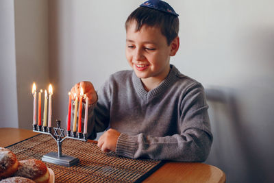 High angle view of boy with tattoo on table