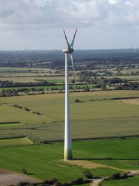 Windmill on field against sky