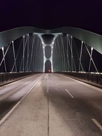 Rear view of woman walking on suspension bridge