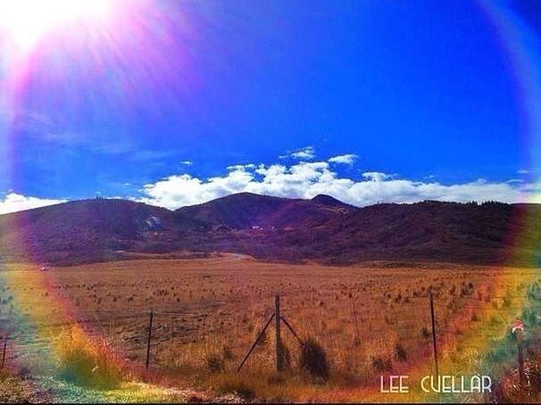 mountain, landscape, scenics, sky, tranquil scene, tranquility, beauty in nature, mountain range, nature, blue, non-urban scene, sunlight, no people, remote, tree, communication, idyllic, outdoors, panoramic, day