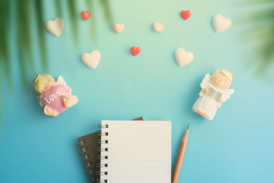 High angle view of paper on table against blue background