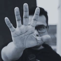 Portrait of man showing stop gesture