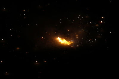 Low angle view of firework display at night