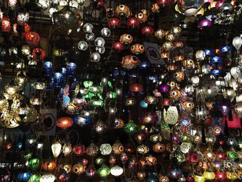 Low angle view of illuminated lanterns hanging at night