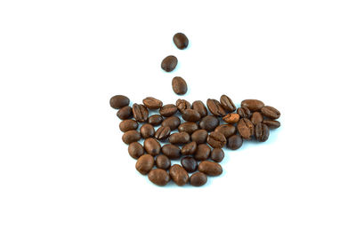High angle view of coffee beans against white background