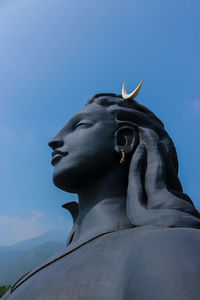 Low angle view of statue against blue sky