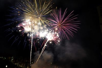 Low angle view of firework display at night