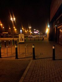 View of illuminated street lights at night