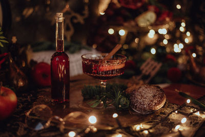 Christmas academia vintage harry potter table - fir, candles, wine, red decor, glasses, gingerbread