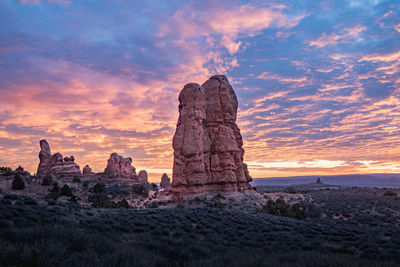 Rock formations against sky during sunset