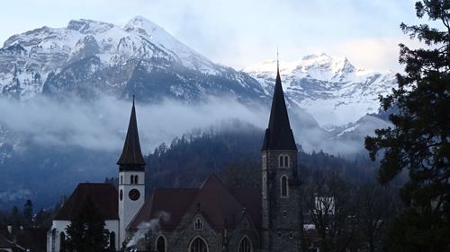 Schlosskirche interlaken by mountain against sky