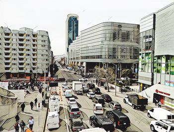 Cars on city street against sky