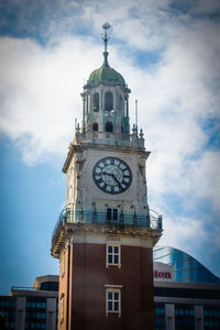 Low angle view of clock tower against sky