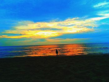 Silhouette of man standing on beach