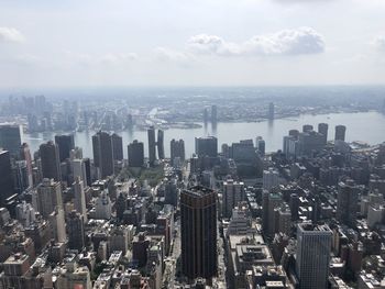 Aerial view of modern buildings in city against sky