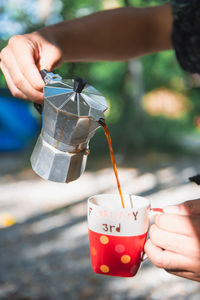 Cropped hand of woman holding coffee