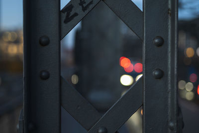 Close-up of illuminated lighting equipment on railing