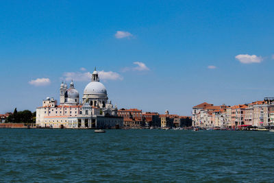 View of sea by city against sky