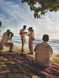 Taking photo on the beach at sunset