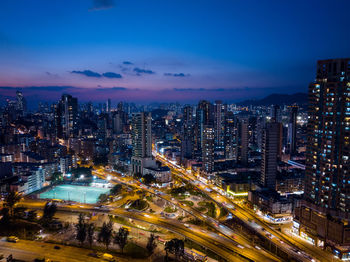 High angle view of illuminated cityscape against sky at night