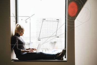 Young female engineer working on laptop