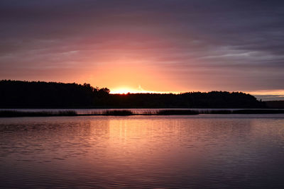 Scenic view of lake against romantic sky at sunset