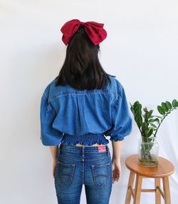 Rear view of woman standing against red wall