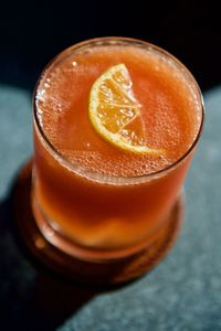 Sunlight falling on strawberry cocktail in glass at table