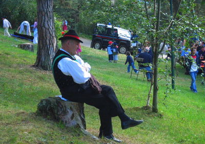 Full length of girl standing on park bench in park