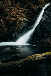 Scenic view of waterfall against sky